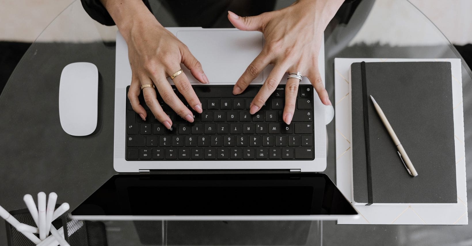A professional woman's hands working on her laptop.